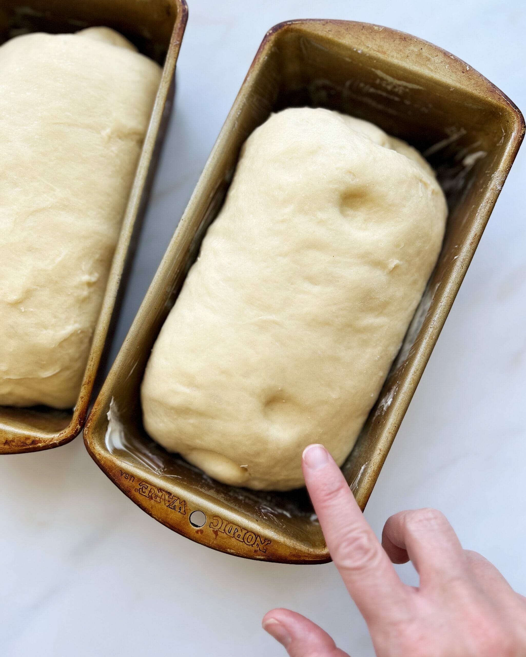 Finger indention on loaf of bread.