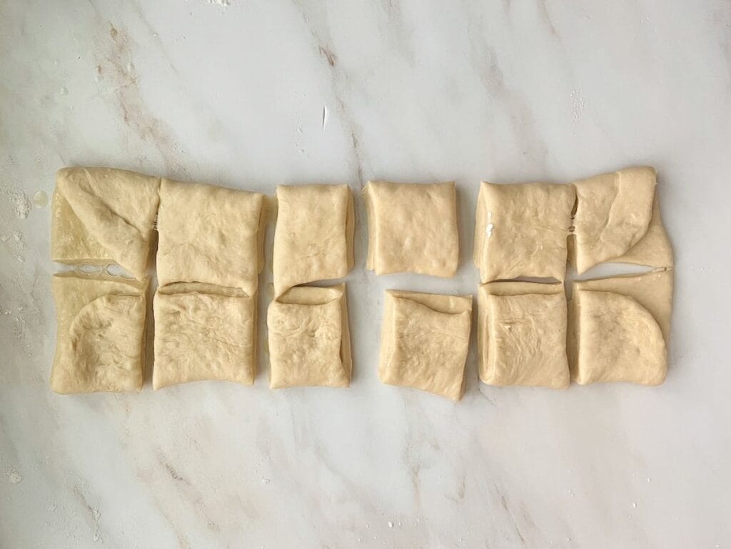 Parker House Rolls dough cut into 12 rolls.