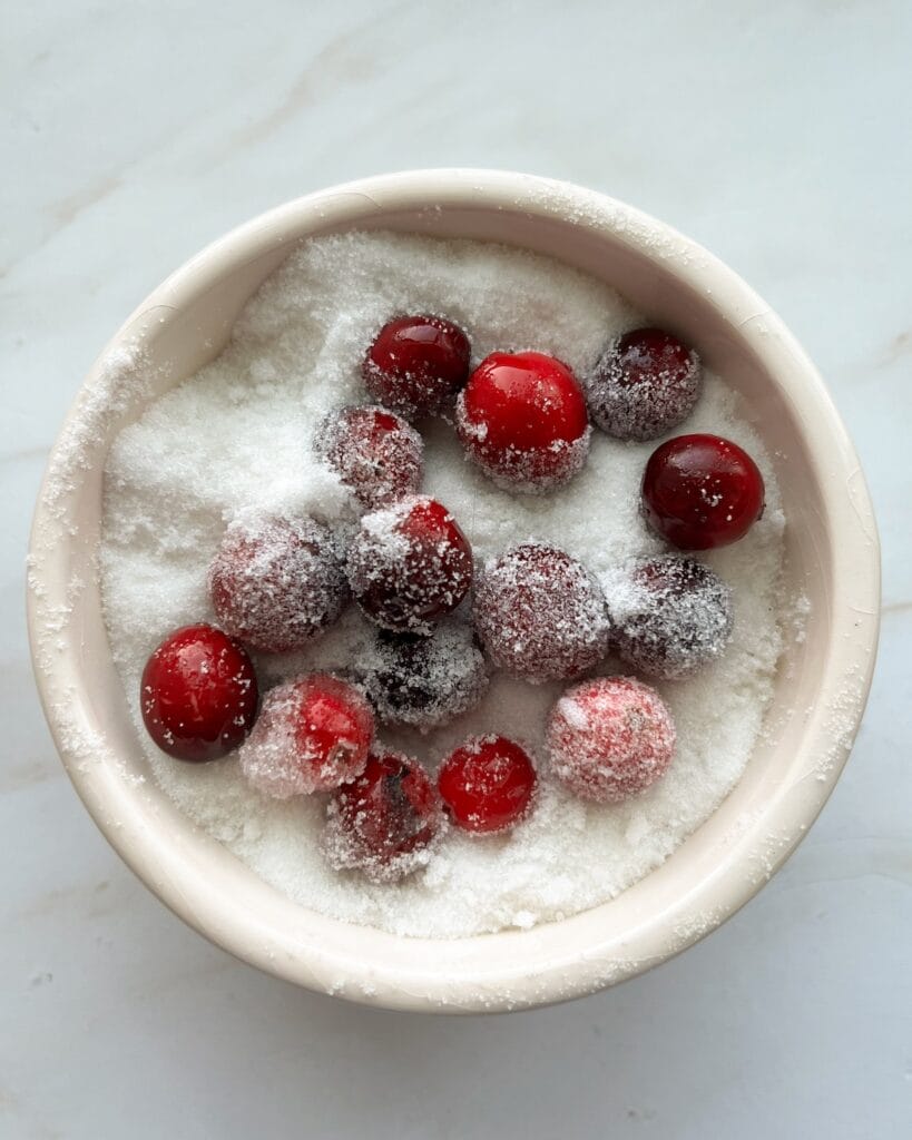 Cranberries in a bowl of sugar.