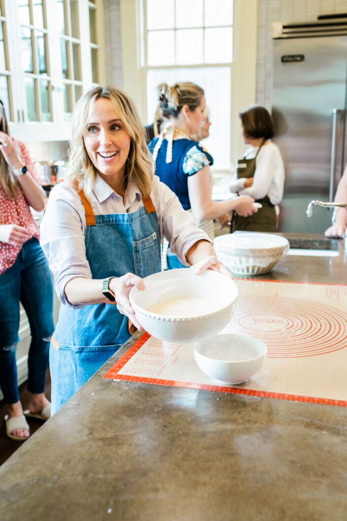 That Bread Lady in a kitchen with several women, making bread